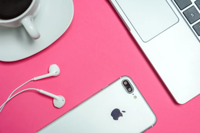 An Apple iPhone and iPods, on a table. 