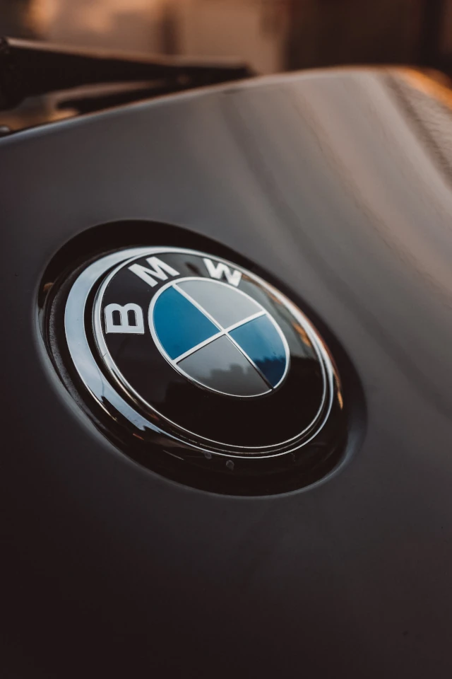 A BMW logo badge on the hood of a car. 