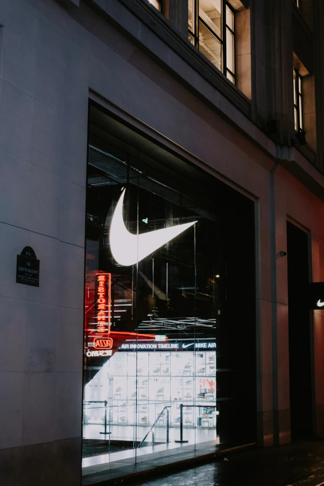 A Nike logo on a store window. 