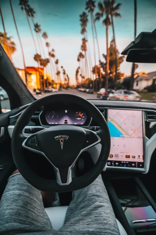A Tesla steering wheel with the logo displayed at the center. 