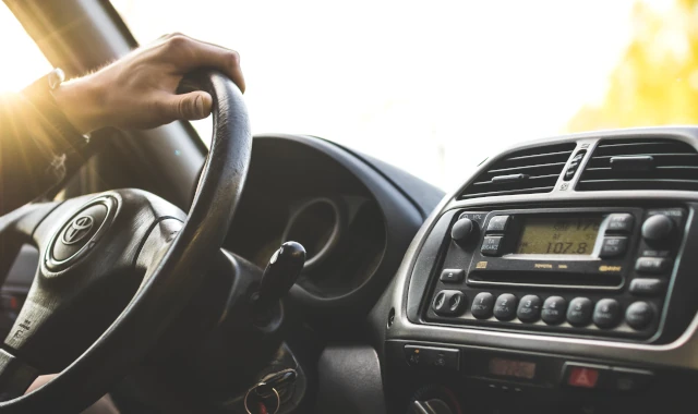 A Toyota logo shown on the steering wheel of one of the company's cars. 