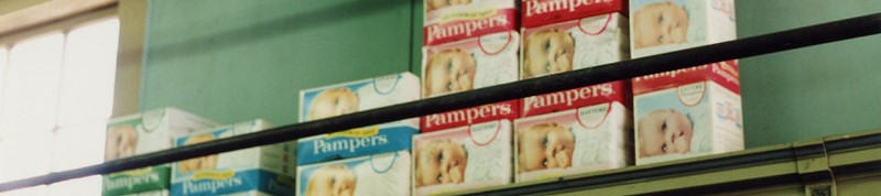 Pampers boxes on a shelf.